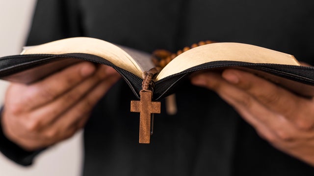 Midsection Of Man Reading Bible 