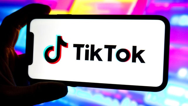 In this photo illustration, a Tik Tok logo is displayed on 