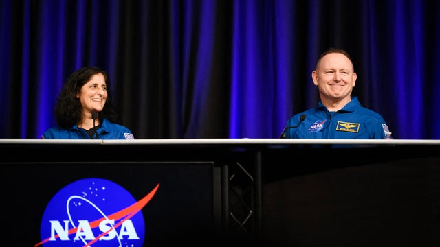 NASA astronauts Suni Williams, left, and Butch Wilmore laugh while answering questions during NASA's SpaceX Crew-9 post-flight news conference at the Johnson Space Center in Houston, Texas, March 31, 2025. 